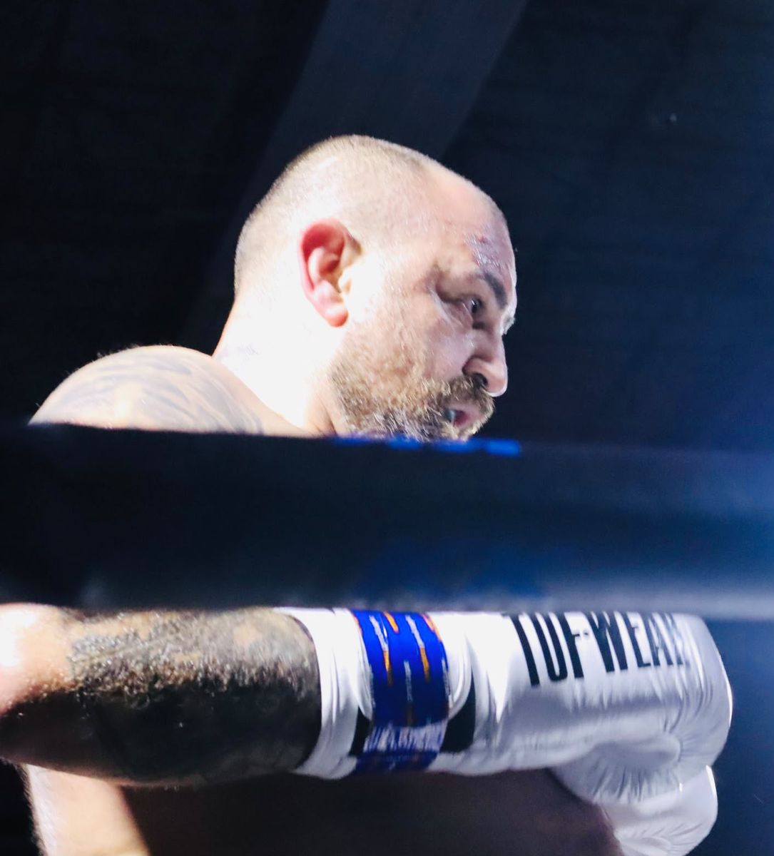 Close-up of a fighter behind the ropes between rounds